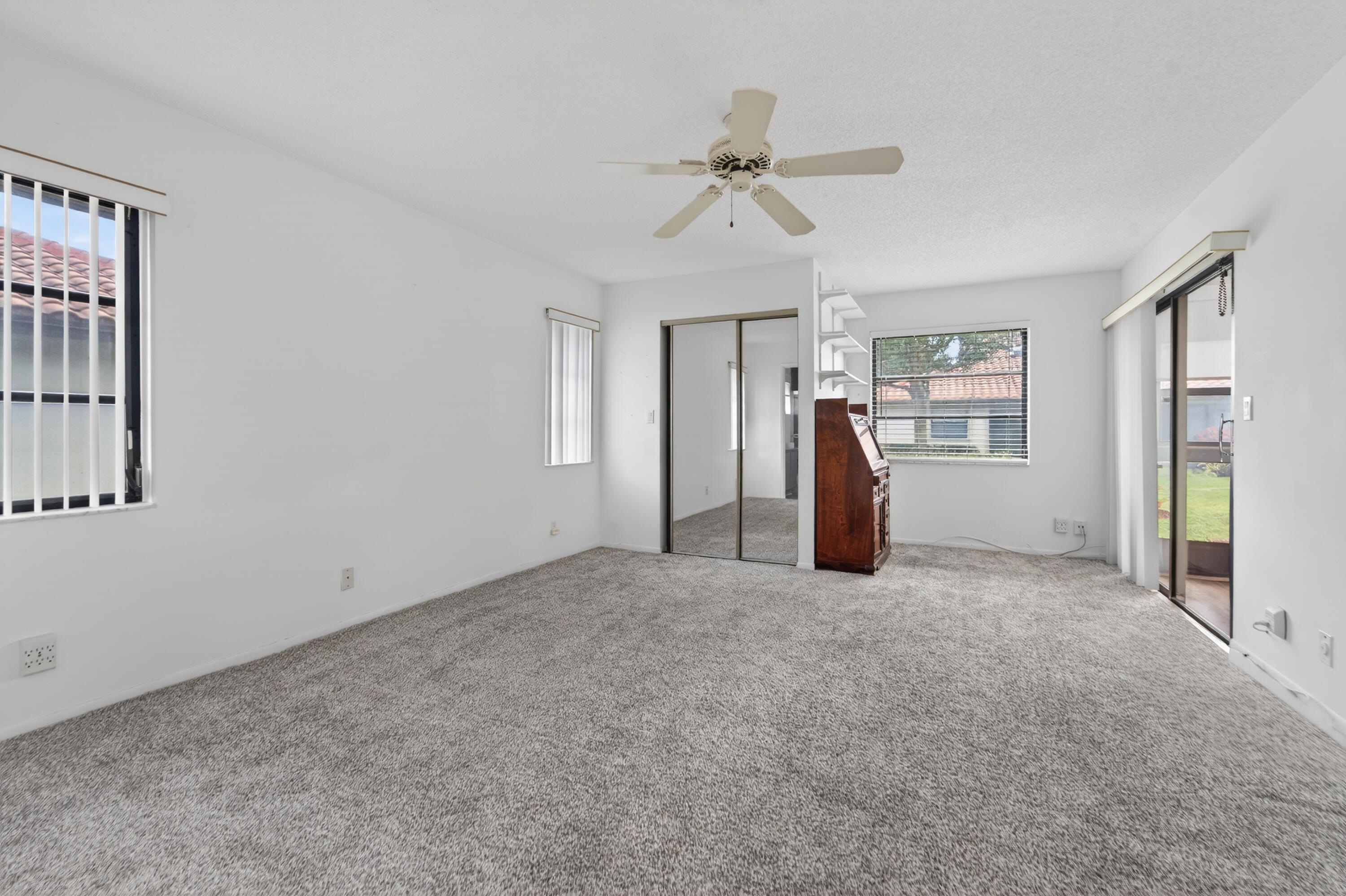 6371 Kings Gate Circle Delray Beach, FL 33484 - Photo 6 of 52 a view of empty room with closet and ceiling fan