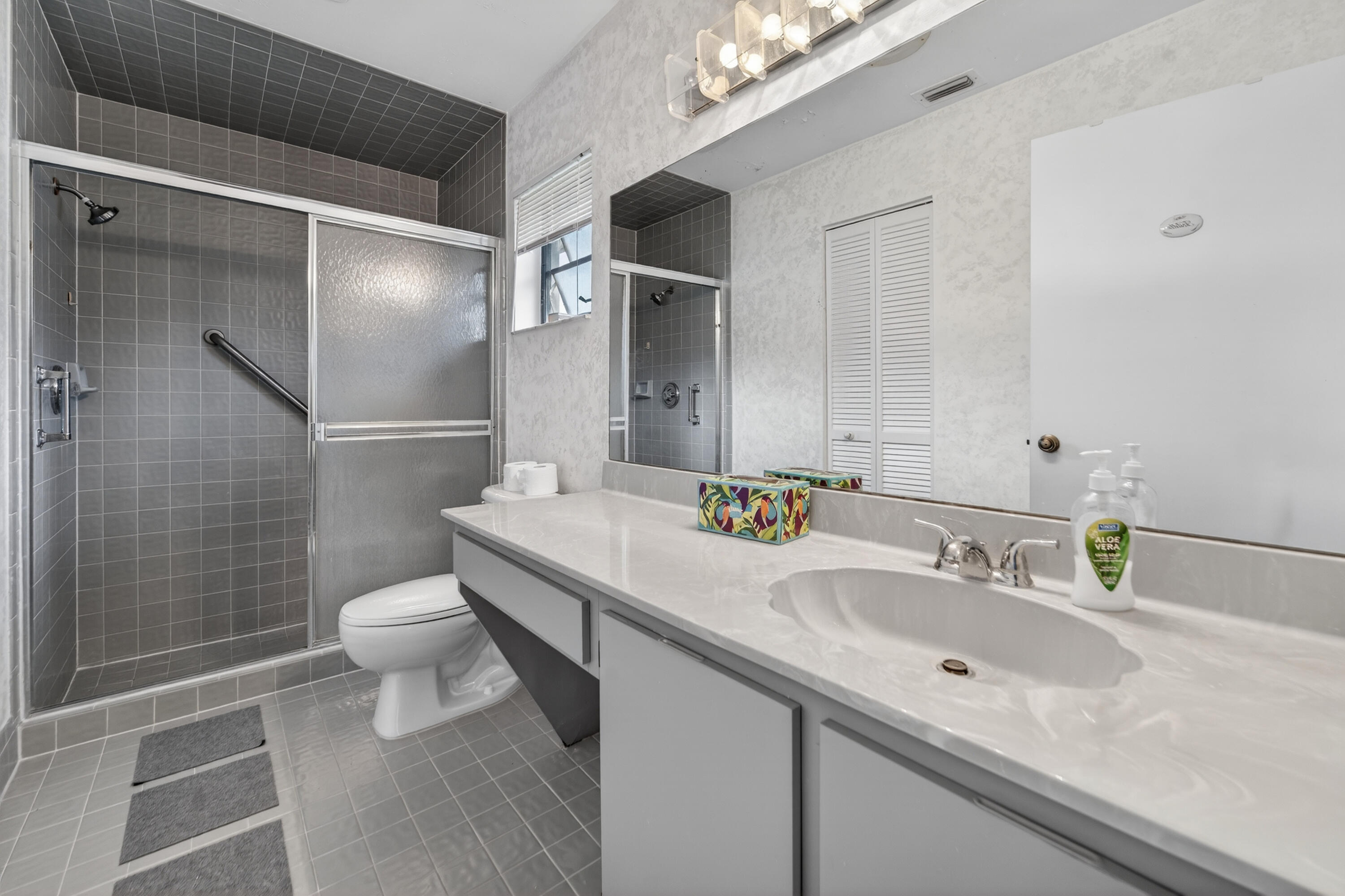 6371 Kings Gate Circle Delray Beach, FL 33484 - Photo 7 of 52 a bathroom with a sink toilet and shower