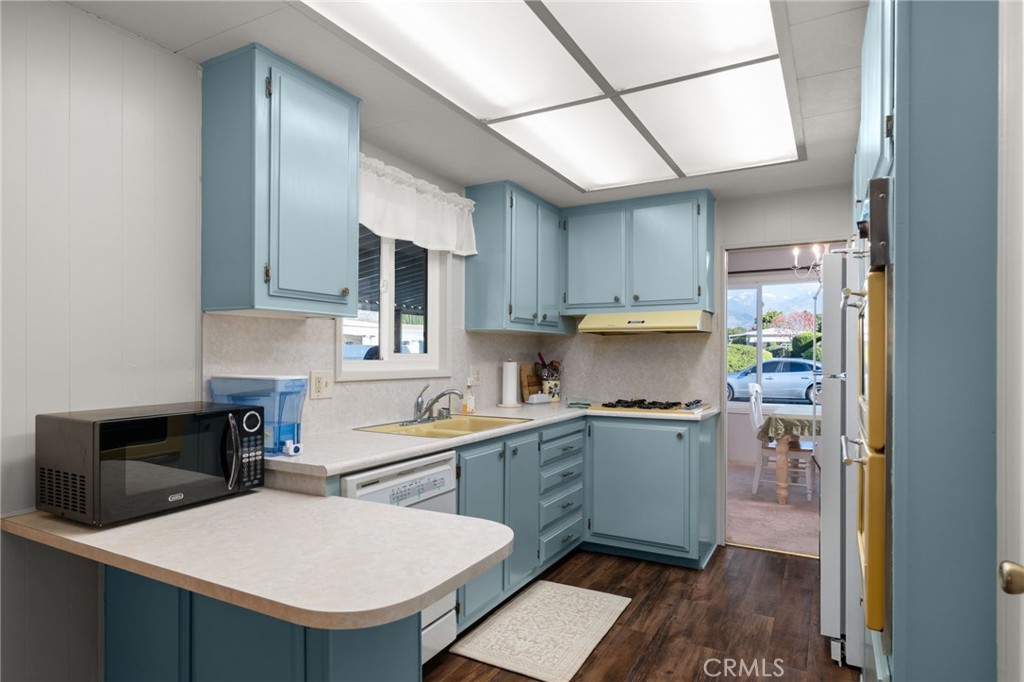 1331 Century Street Redlands, CA 92374 - Photo 12 of 35 a kitchen with a sink a stove and chairs