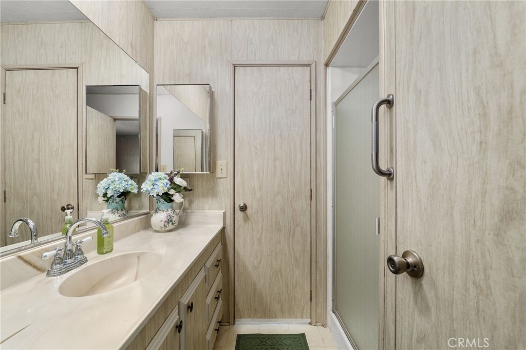 1331 Century Street Redlands, CA 92374 - Photo 23 of 35 a bathroom with a granite countertop sink vanity mirror and shower