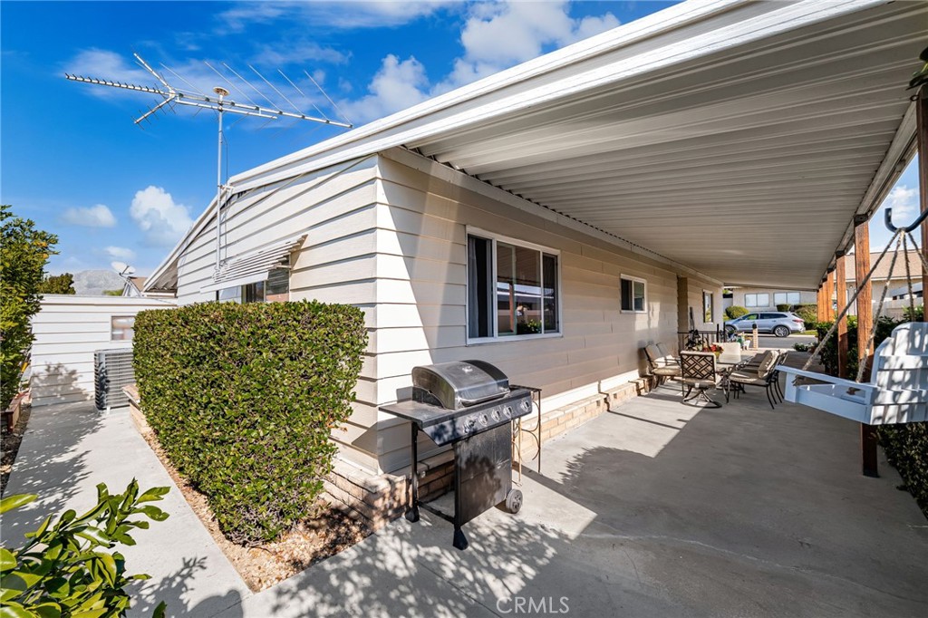 1331 Century Street Redlands, CA 92374 - Photo 26 of 35 a view of a patio with table and chairs with wooden floor and fence