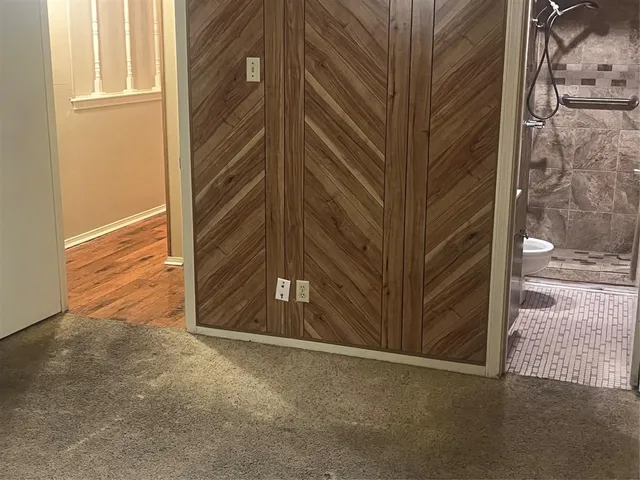 a view of a house with a door and wooden walls