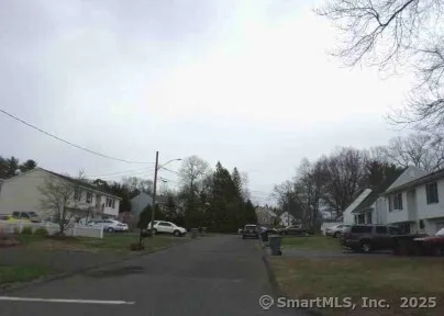a view of street with parked cars