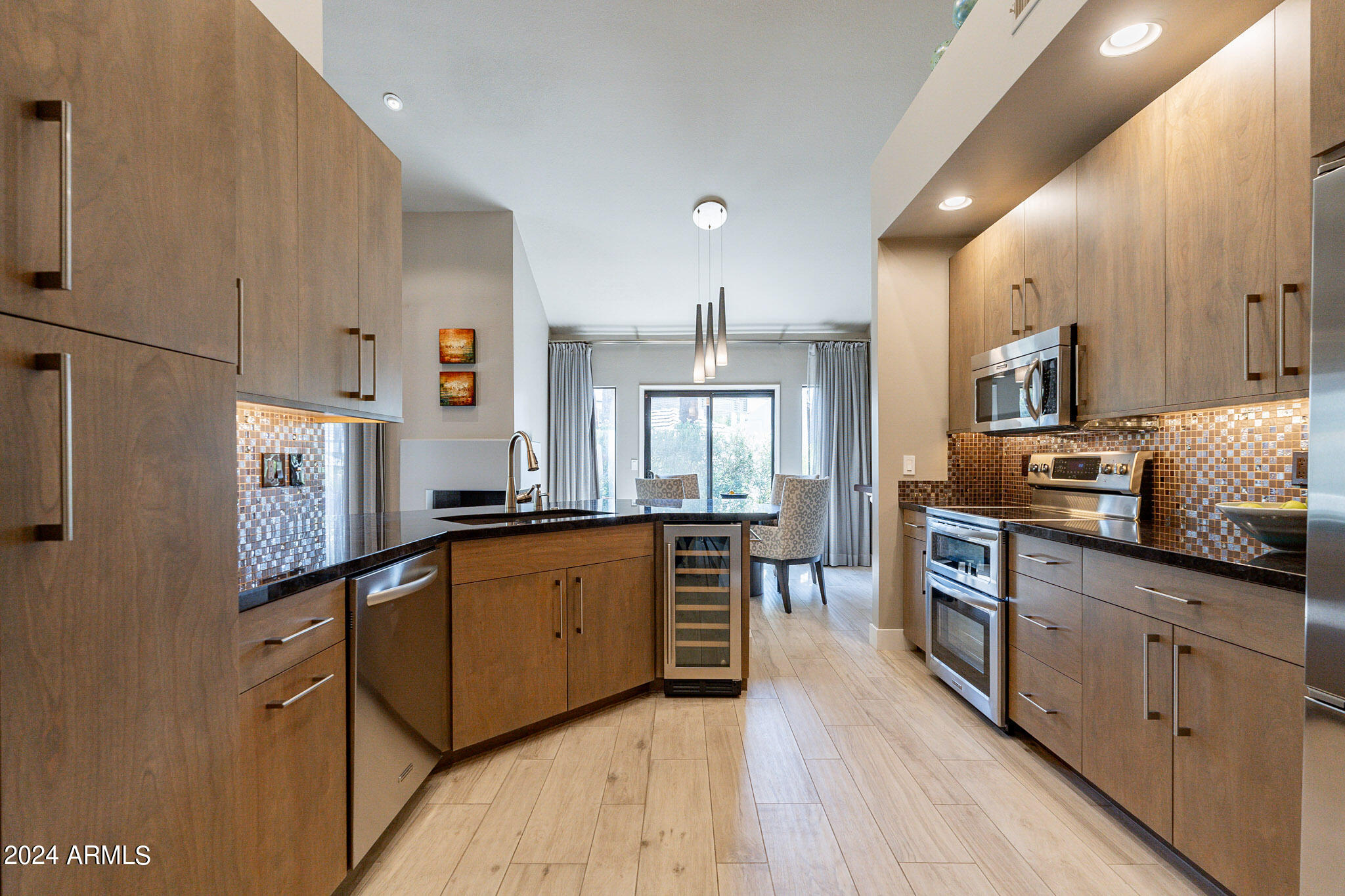 7272 East Gainey Ranch Road, Unit 101 Scottsdale, AZ 85258 - Photo 12 of 36 a large kitchen with stainless steel appliances lots of counter top space