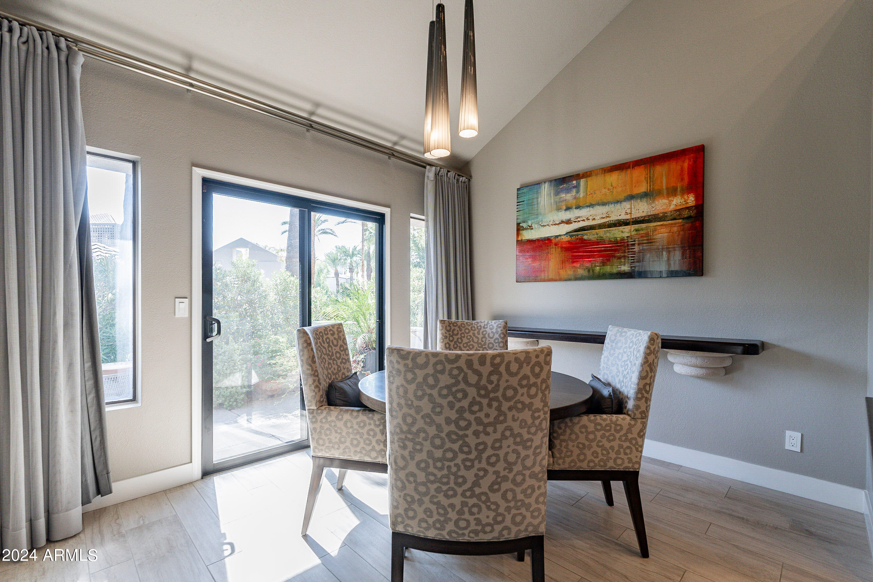 7272 East Gainey Ranch Road, Unit 101 Scottsdale, AZ 85258 - Photo 14 of 36 a view of a dining room with furniture wooden floor and a chandelier