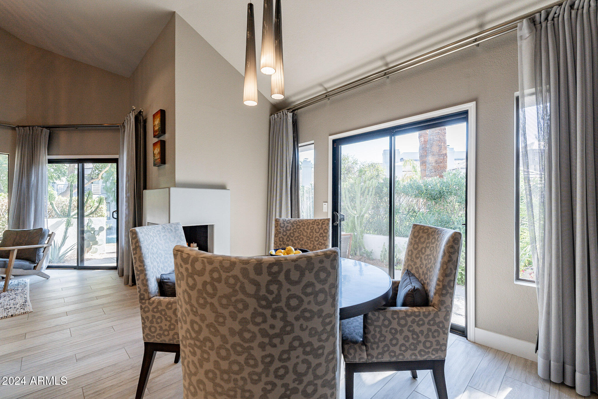 7272 East Gainey Ranch Road, Unit 101 Scottsdale, AZ 85258 - Photo 15 of 36 a view of a dining room with furniture window and wooden floor