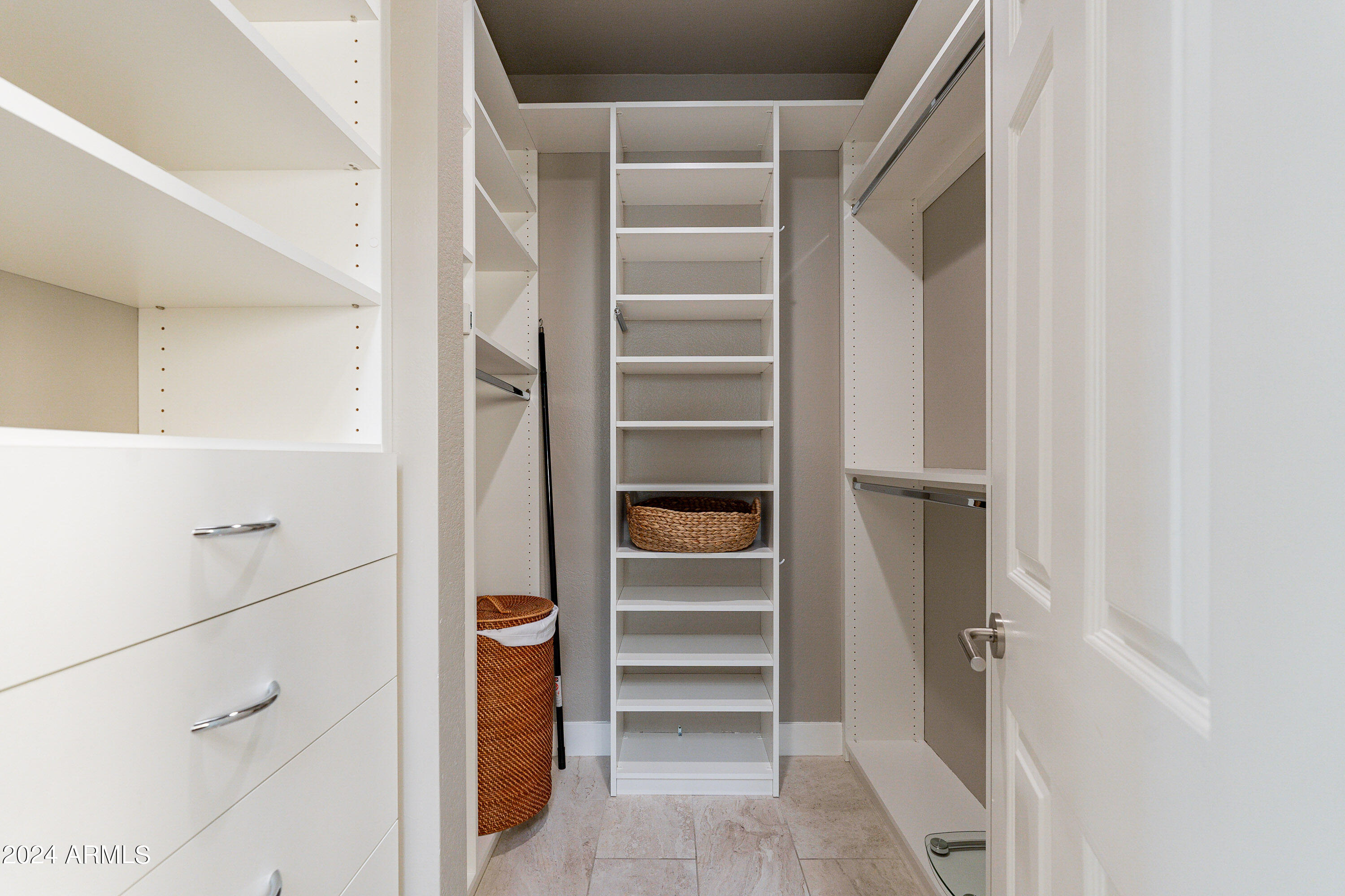 7272 East Gainey Ranch Road, Unit 101 Scottsdale, AZ 85258 - Photo 20 of 36 a view of walk in closet with empty racks
