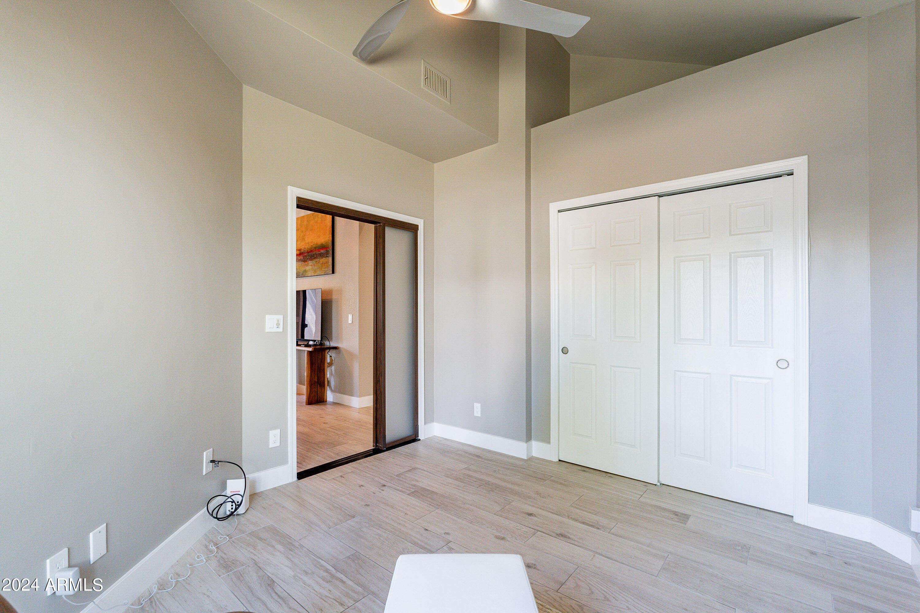 7272 East Gainey Ranch Road, Unit 101 Scottsdale, AZ 85258 - Photo 22 of 36 wooden floor in an empty room with a window