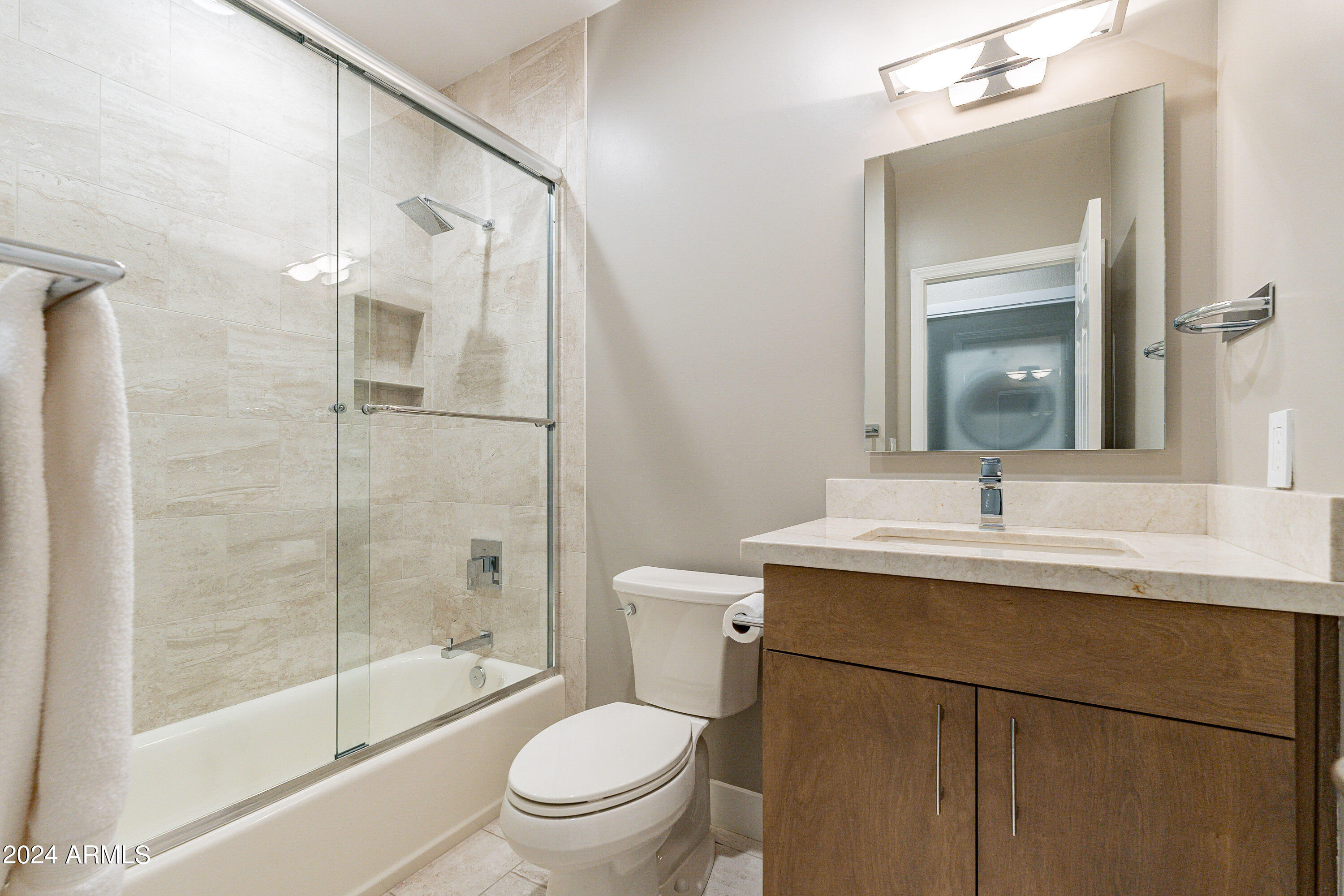 7272 East Gainey Ranch Road, Unit 101 Scottsdale, AZ 85258 - Photo 23 of 36 a bathroom with a sink toilet and shower