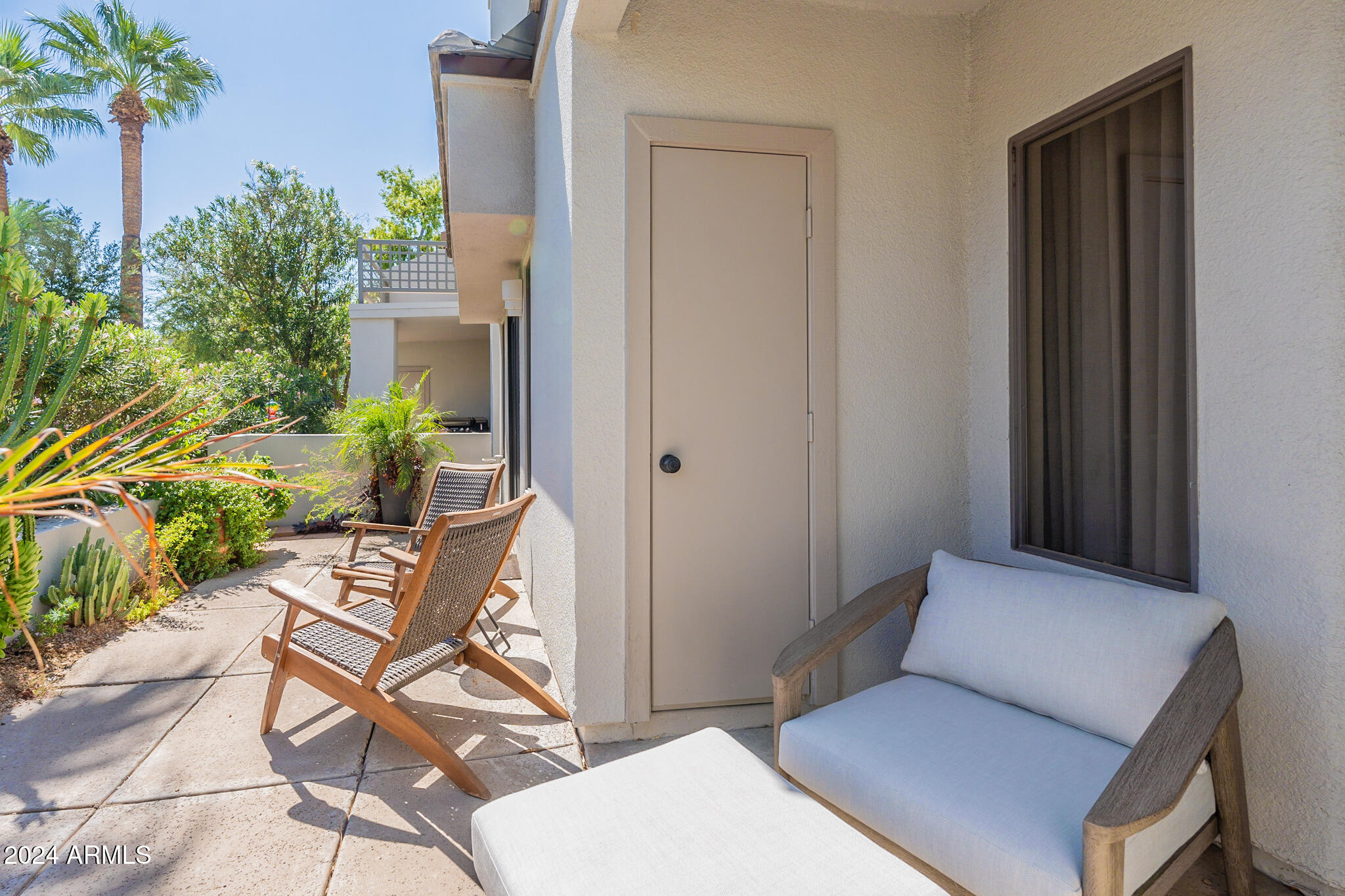 7272 East Gainey Ranch Road, Unit 101 Scottsdale, AZ 85258 - Photo 27 of 36 a balcony with furniture and potted plants