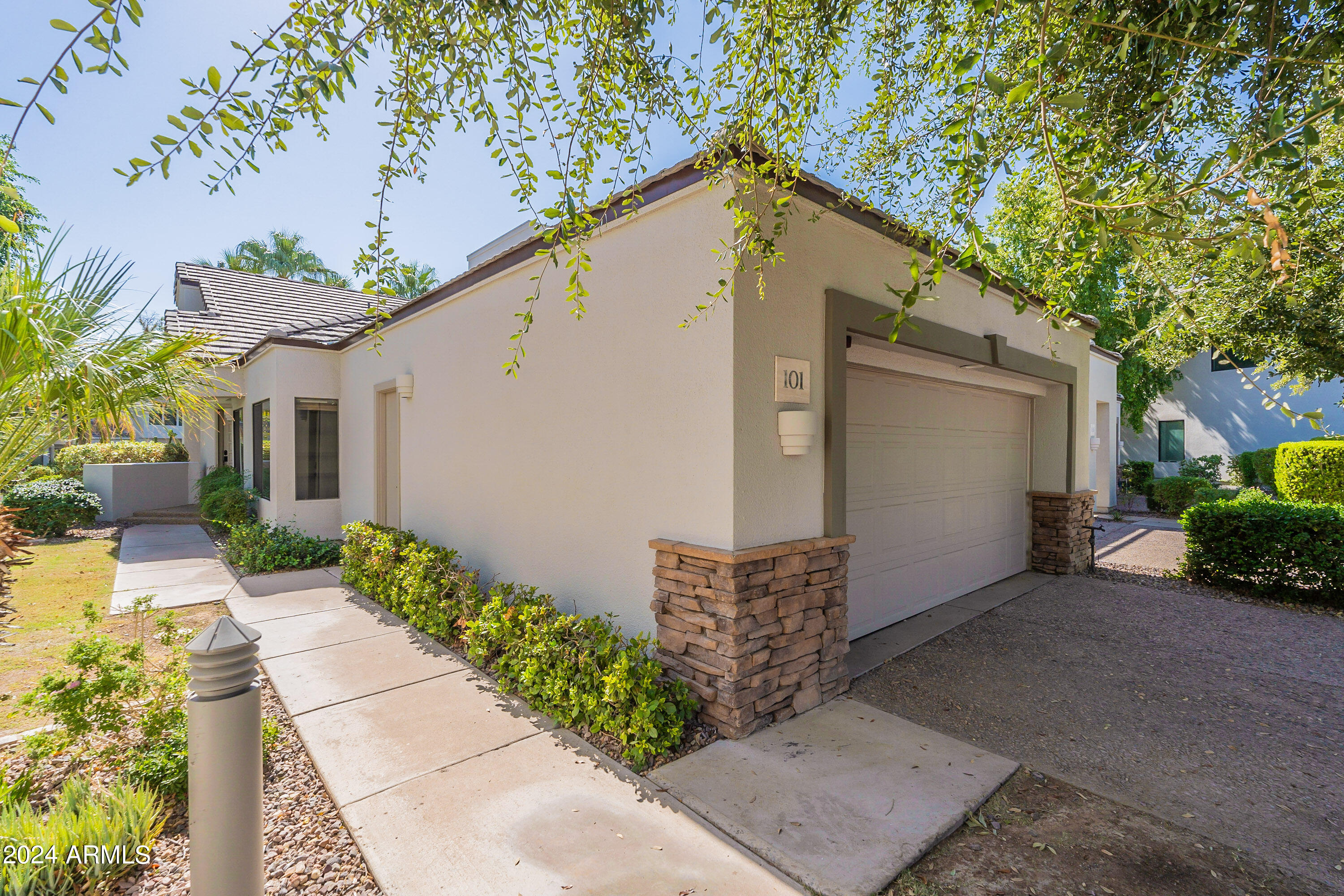 7272 East Gainey Ranch Road, Unit 101 Scottsdale, AZ 85258 - Photo 29 of 36 a view of a house with a yard