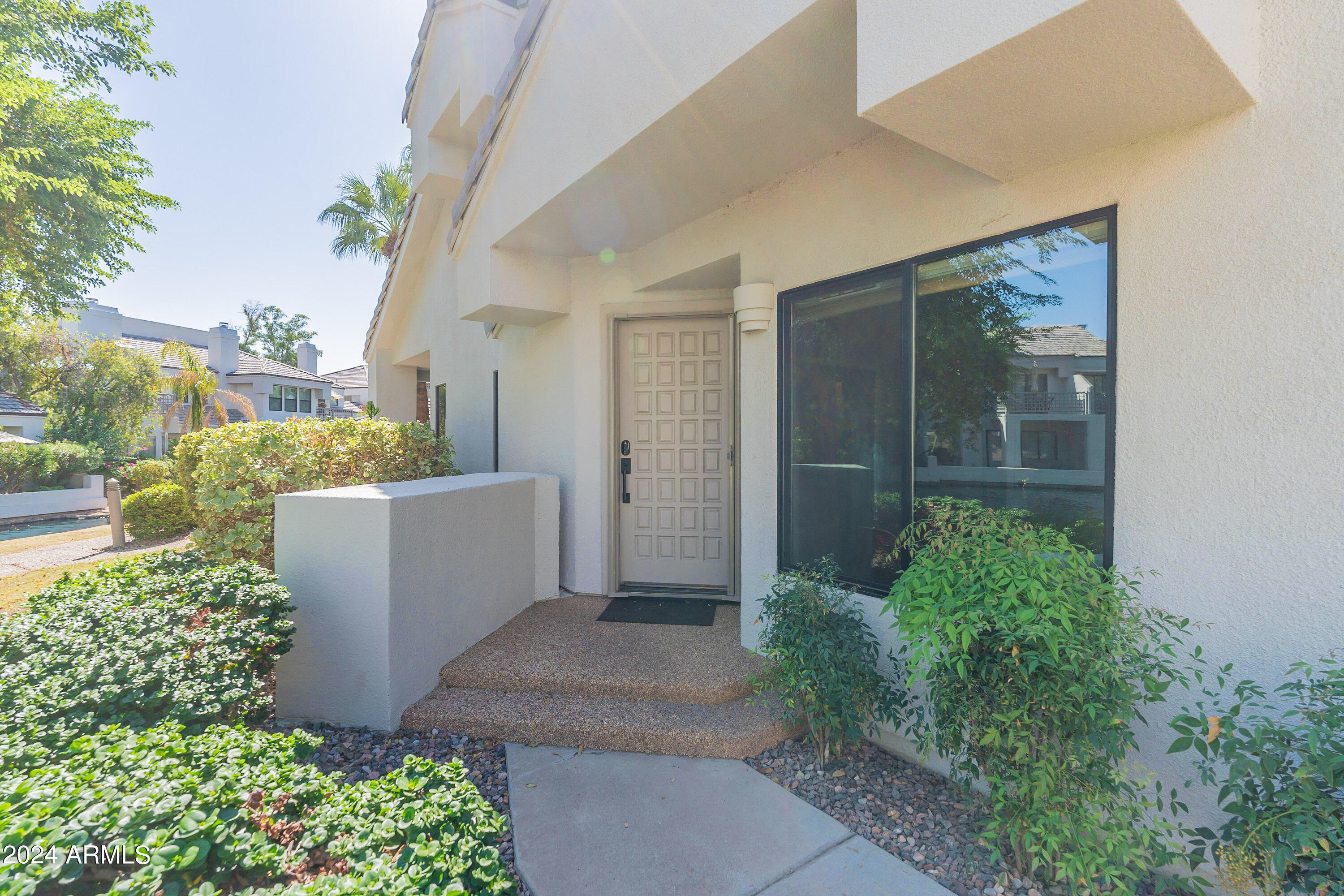 7272 East Gainey Ranch Road, Unit 101 Scottsdale, AZ 85258 - Photo 3 of 36 front view of a house with a yard