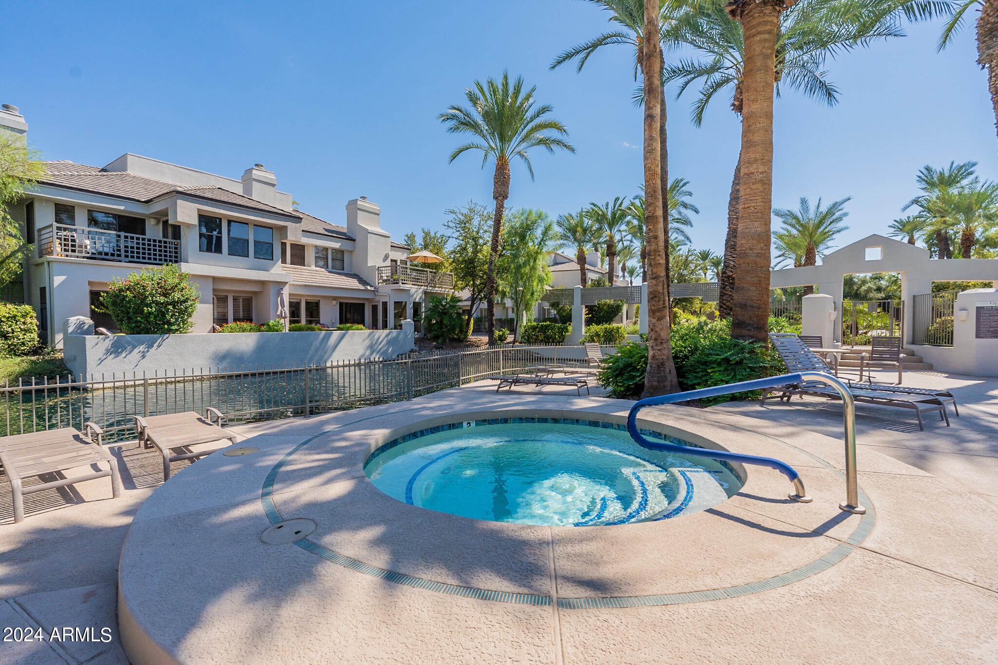 7272 East Gainey Ranch Road, Unit 101 Scottsdale, AZ 85258 - Photo 31 of 36 a view of a swimming pool with a patio