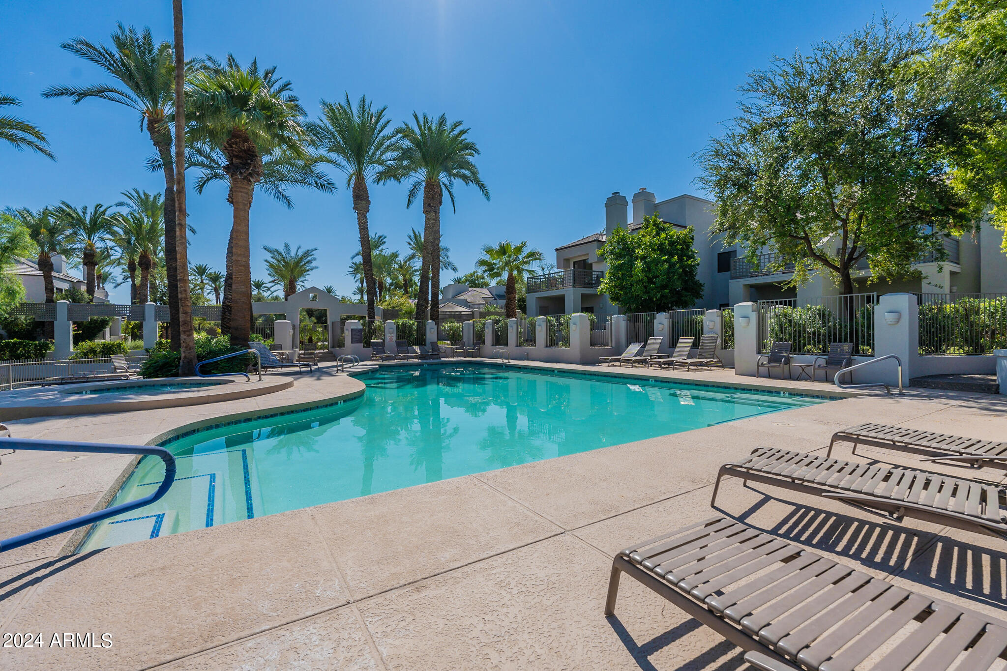 7272 East Gainey Ranch Road, Unit 101 Scottsdale, AZ 85258 - Photo 32 of 36 a view of a swimming pool with a patio and a yard