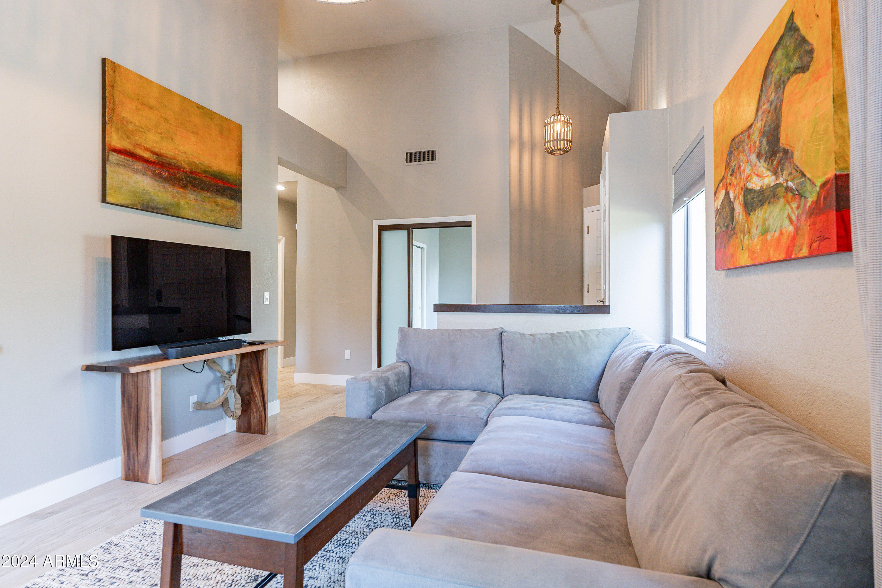 7272 East Gainey Ranch Road, Unit 101 Scottsdale, AZ 85258 - Photo 8 of 36 a living room with furniture and a flat screen tv