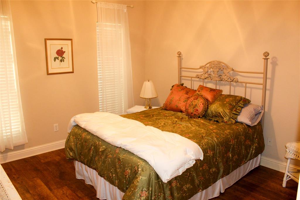 110 Bay Tree Trail Mabank, TX 75156 - Photo 15 of 20 a bedroom with a bed and a night stand