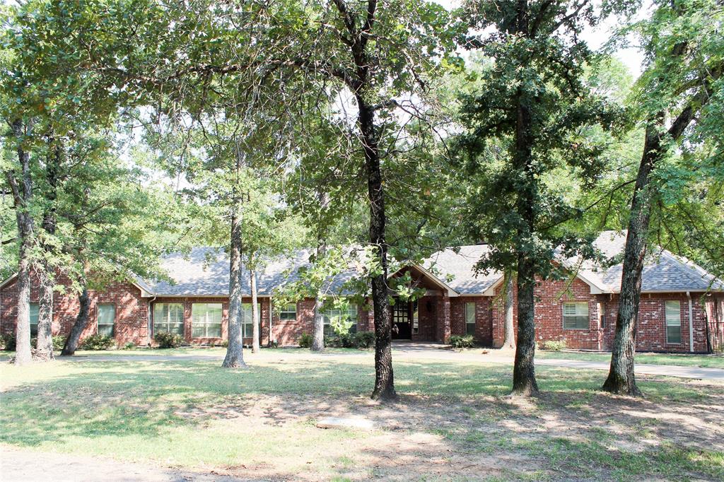 110 Bay Tree Trail Mabank, TX 75156 - Photo 2 of 20 a house in middle of the forest