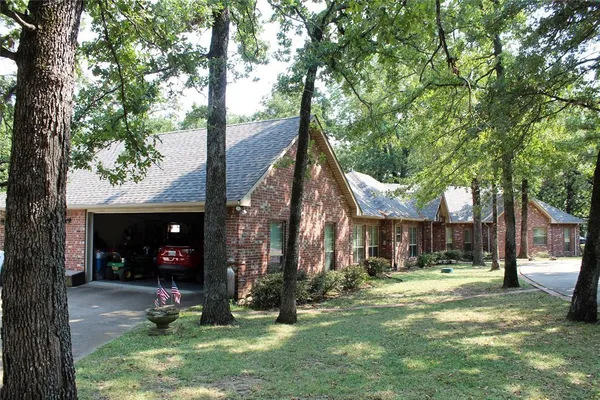 a view of a house with a yard and tree s