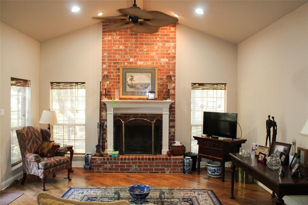 110 Bay Tree Trail Mabank, TX 75156 - Photo 4 of 20 a living room with furniture a fireplace and a flat screen tv