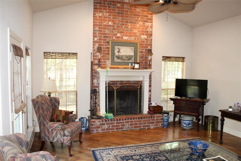 110 Bay Tree Trail Mabank, TX 75156 - Photo 6 of 20 a living room with furniture a fireplace and a flat screen tv