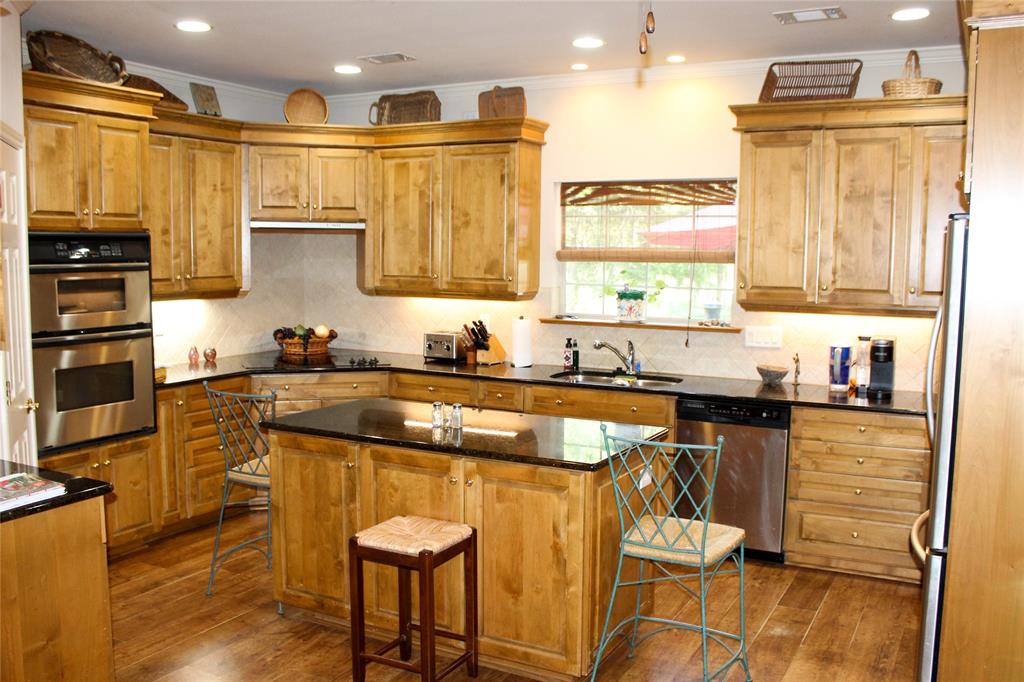 110 Bay Tree Trail Mabank, TX 75156 - Photo 8 of 20 a kitchen with stainless steel appliances granite countertop a stove a sink and a refrigerator