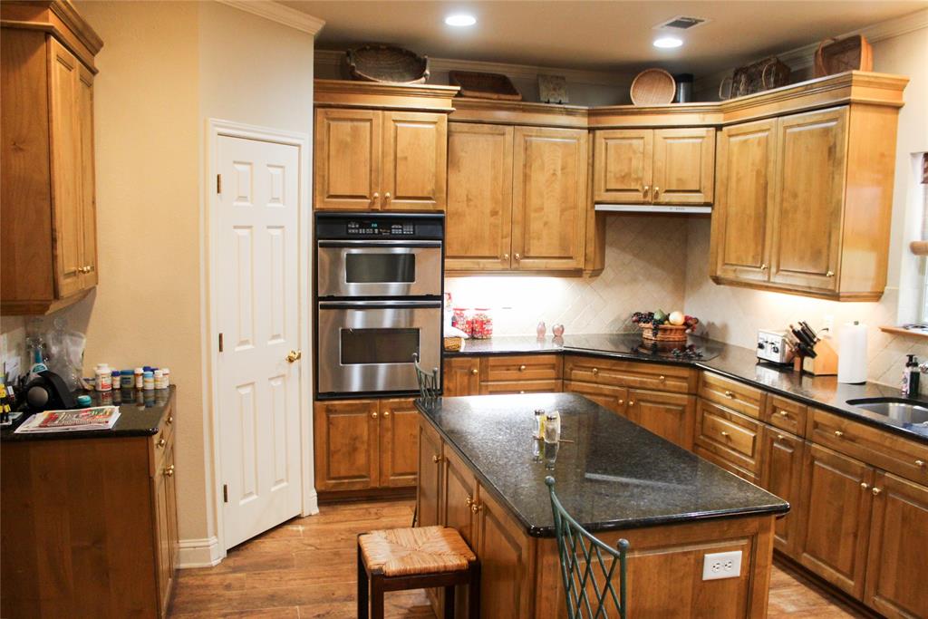 110 Bay Tree Trail Mabank, TX 75156 - Photo 9 of 20 a kitchen with stainless steel appliances granite countertop a refrigerator and a stove top oven