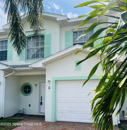 a view of a house with a palm tree