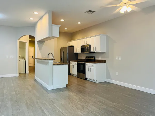 a kitchen with stainless steel appliances a refrigerator and a stove top oven
