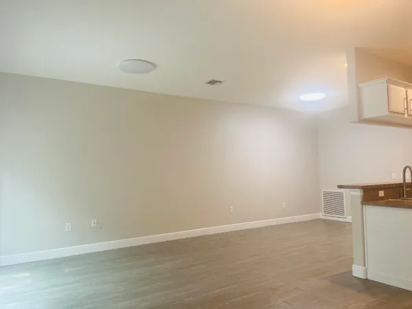a view of bathroom with small space and wooden floor