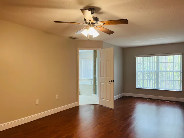a bathroom with a tub a sink and mirror