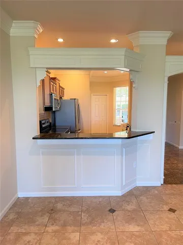 a view of a hallway with a chair and a mirror