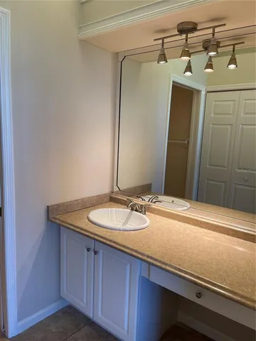 a bathroom with a granite countertop sink and mirror