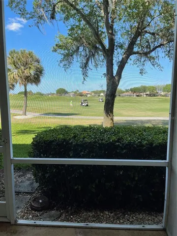 a view of a yard with wooden fence