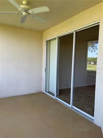 an empty room with closet and a window