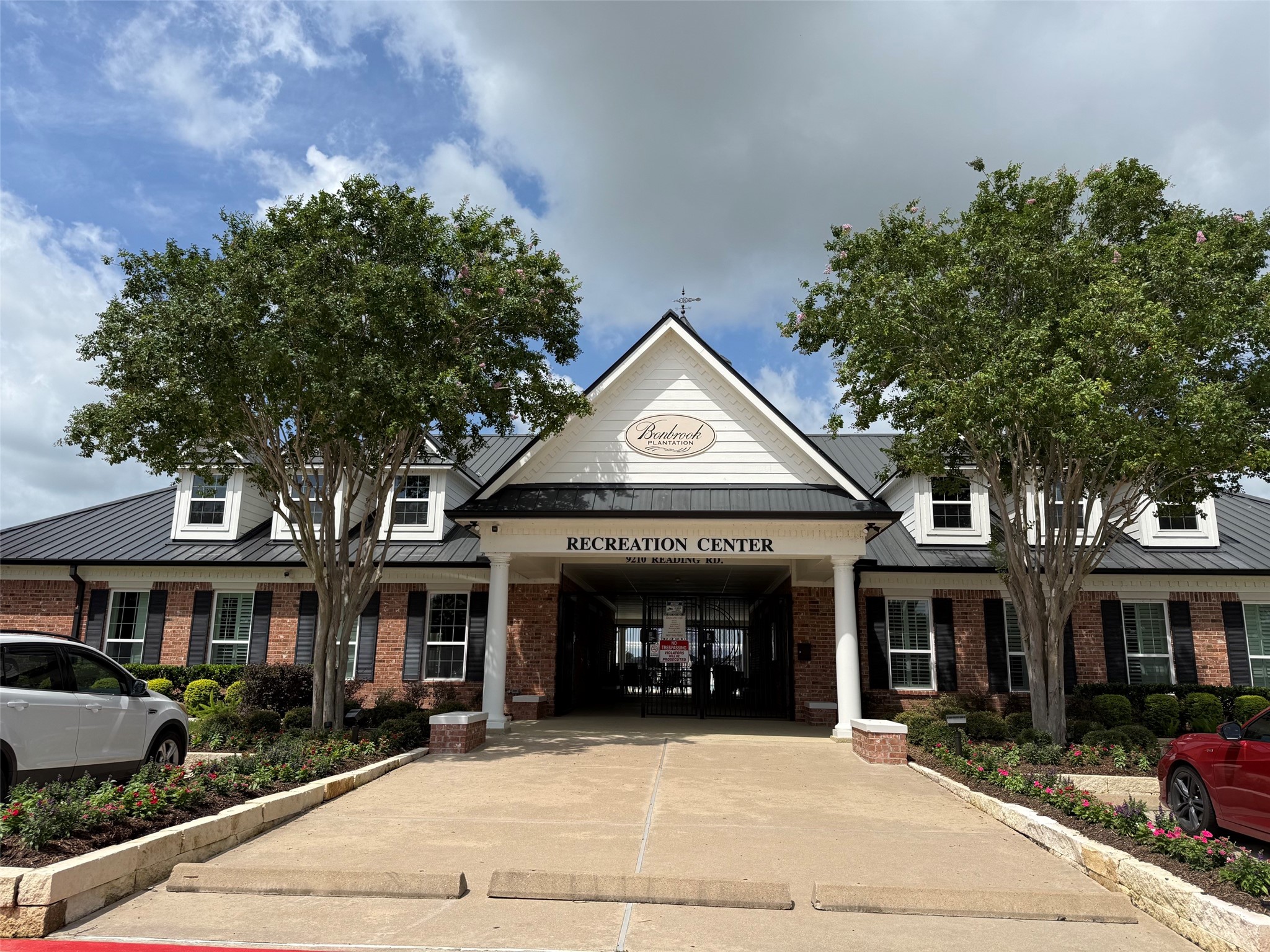 8911 Henrico Lane Rosenberg, TX 77469 - Photo 36 of 45 a front view of a building with lots of trees and plants