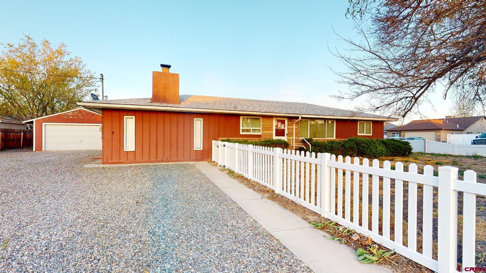 a view of a house with wooden fence