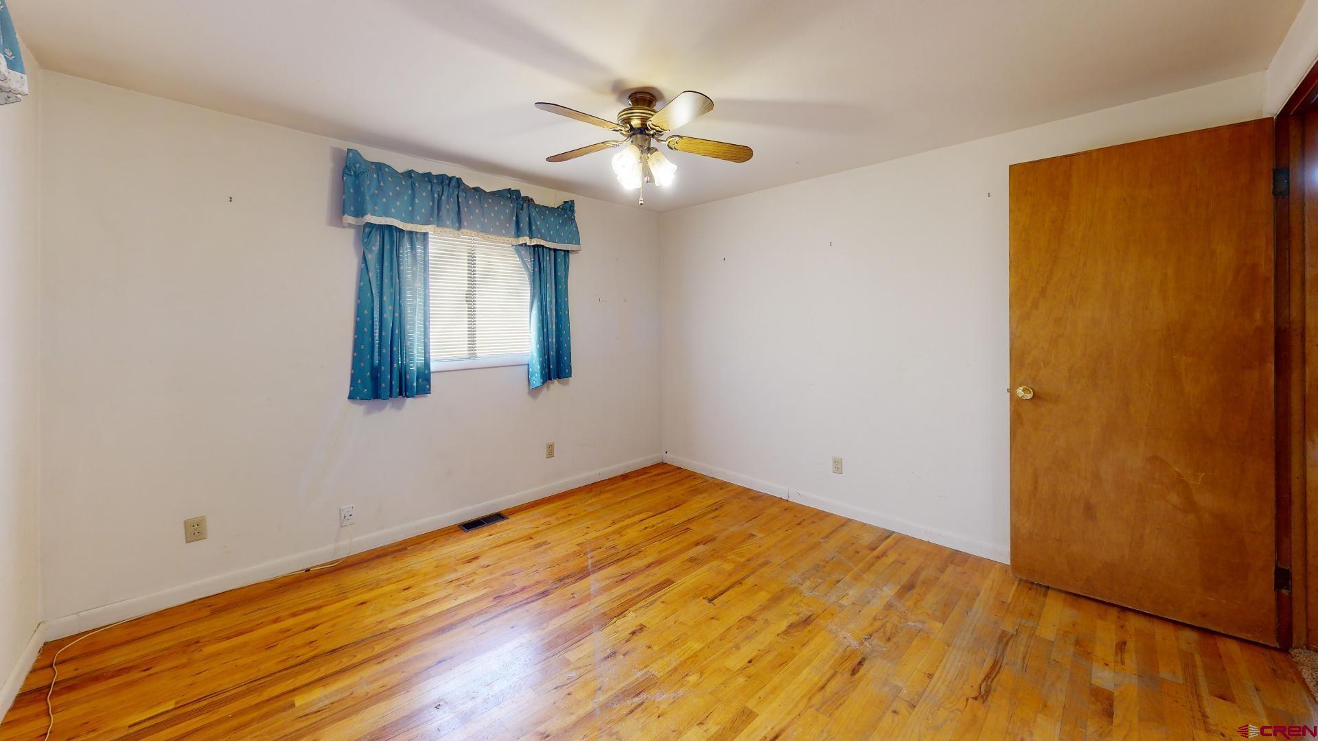 420 30 1/4 Road Grand Junction, CO 81504 - Photo 11 of 13 a view of empty room with wooden floor and fan