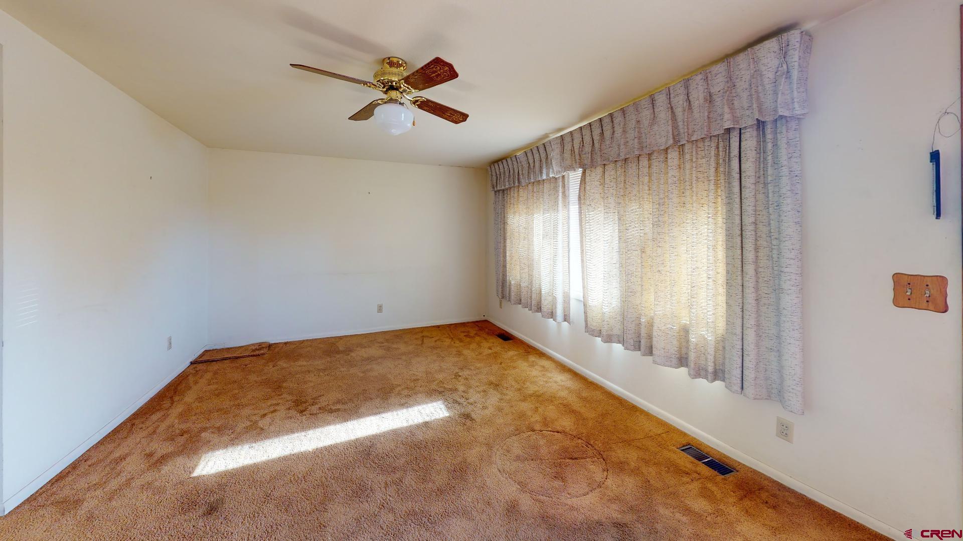 420 30 1/4 Road Grand Junction, CO 81504 - Photo 3 of 13 an empty room with a empty space and windows