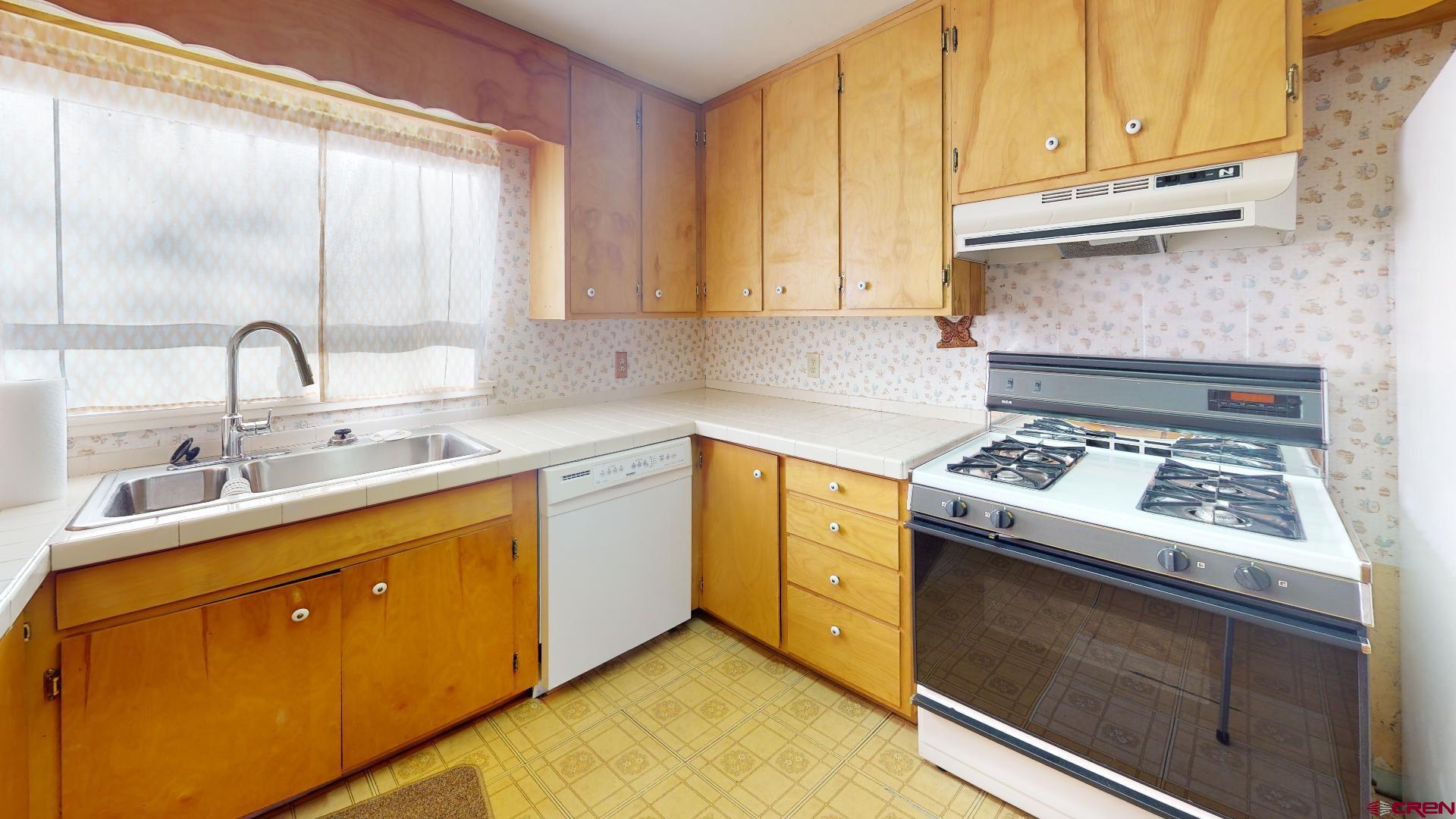 420 30 1/4 Road Grand Junction, CO 81504 - Photo 4 of 13 a kitchen with a sink stove and cabinets