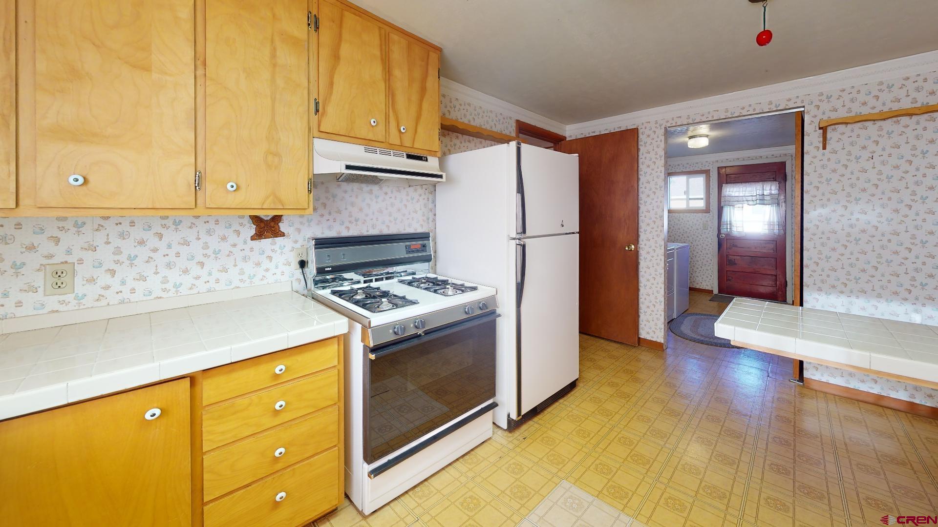 420 30 1/4 Road Grand Junction, CO 81504 - Photo 5 of 13 a kitchen with sink a refrigerator and cabinets
