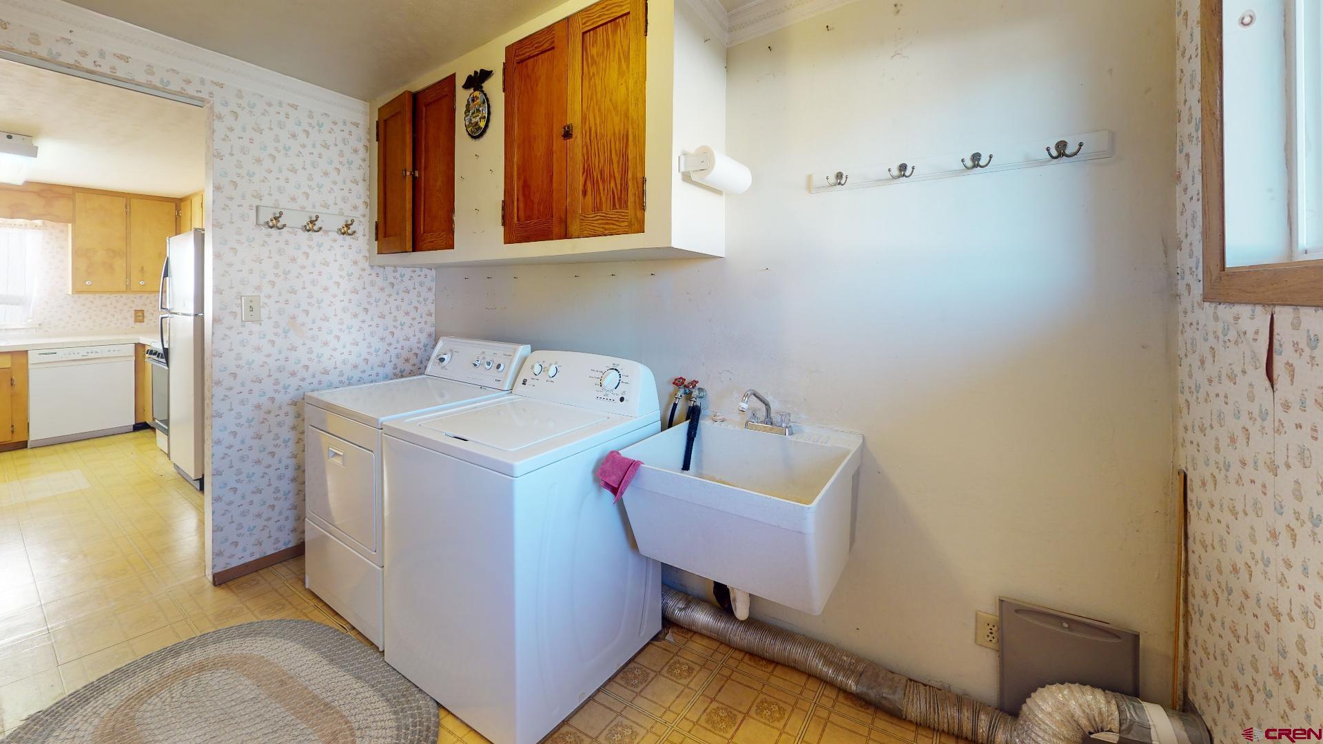 420 30 1/4 Road Grand Junction, CO 81504 - Photo 8 of 13 a storage room with wooden floor washer and dryer
