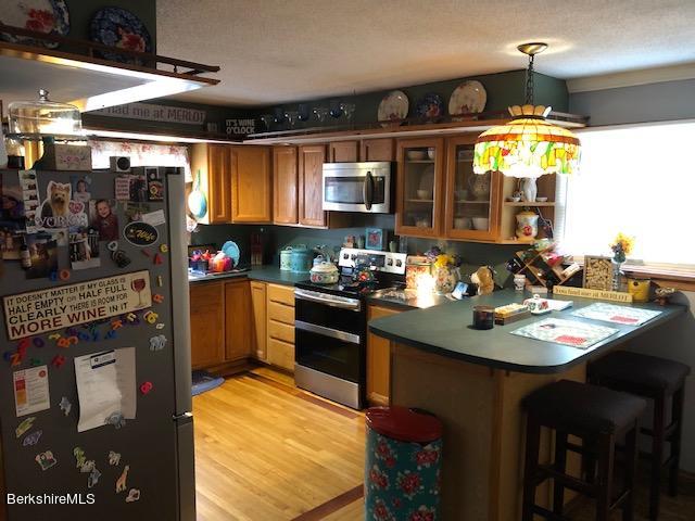 181 Matteson Road Bennington, VT 05257 - Photo 2 of 25 a kitchen with a sink appliances and cabinets