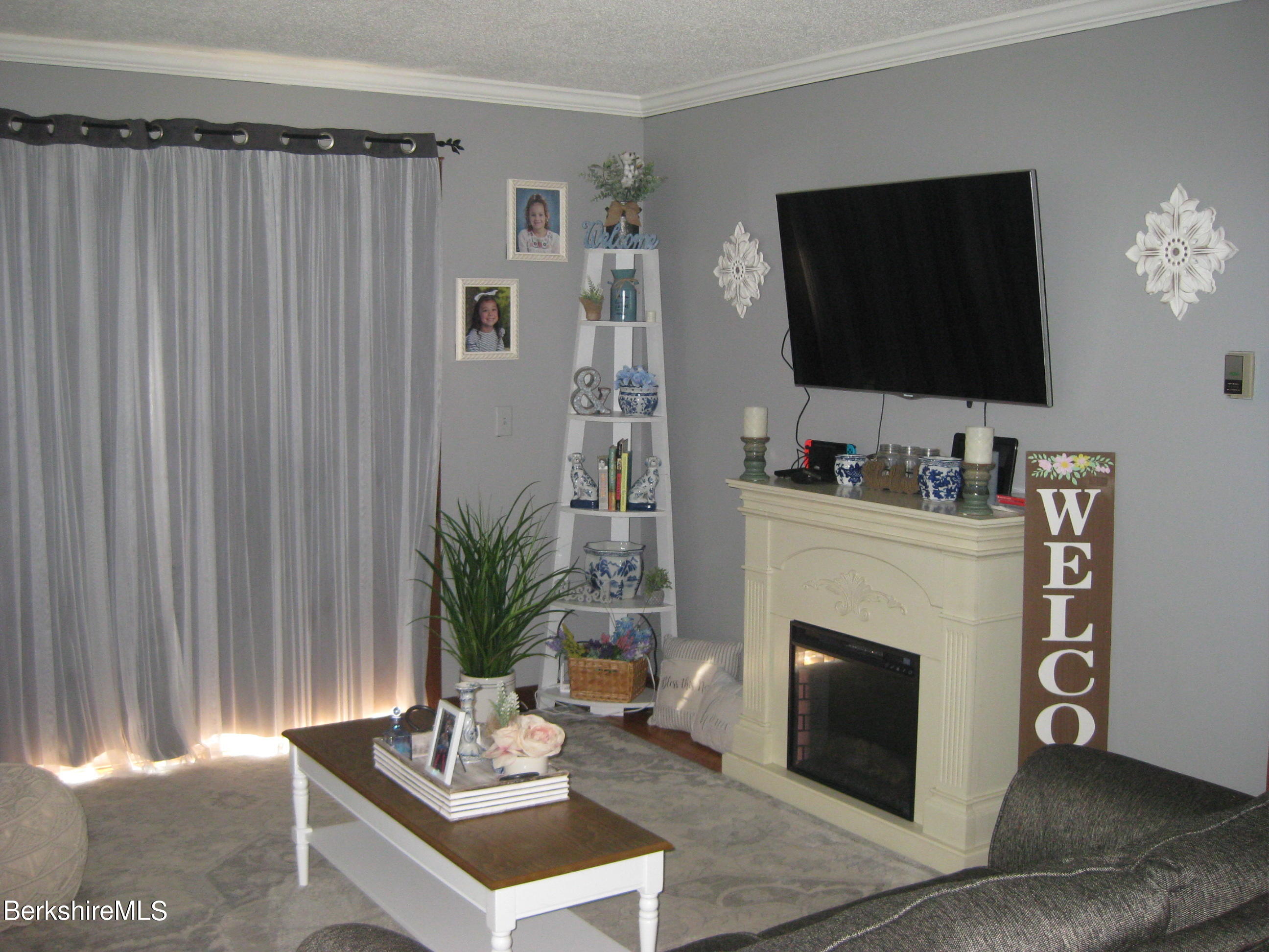 181 Matteson Road Bennington, VT 05257 - Photo 7 of 25 a living room with furniture a fireplace and a flat screen tv