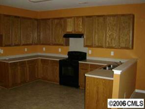 1037 Garrison Road Charlotte, NC 28262 - Photo 4 of 8 a kitchen with a sink and cabinets