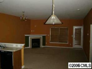 1037 Garrison Road Charlotte, NC 28262 - Photo 5 of 8 a living room with a fireplace