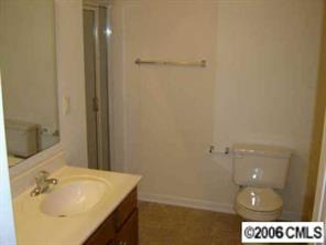 1037 Garrison Road Charlotte, NC 28262 - Photo 6 of 8 a bathroom with a sink and a mirror