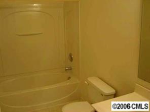 1037 Garrison Road Charlotte, NC 28262 - Photo 7 of 8 a bathroom with a toilet and a shower
