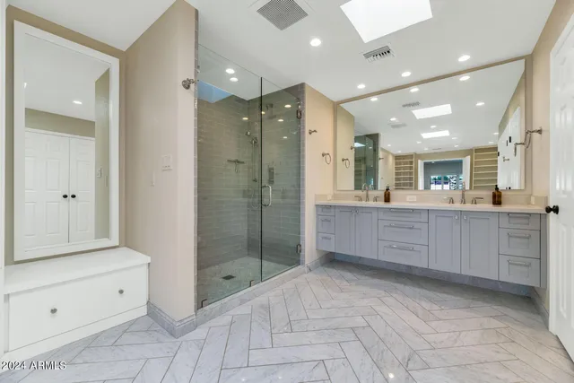 a bathroom with a shower sink and mirror