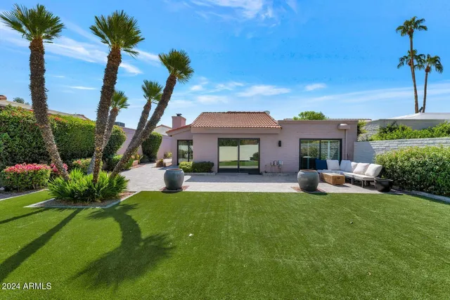 a view of a backyard with plants and a garden