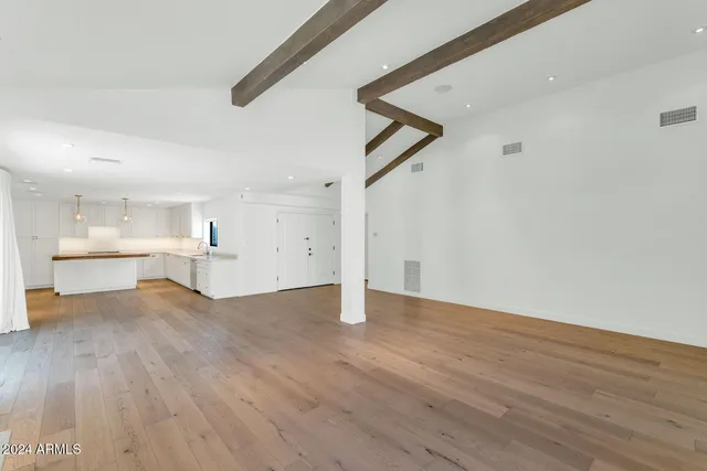 a view of a kitchen with wooden floor and a sink